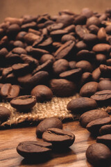 Coffee beans on sackcloth, wooden table
