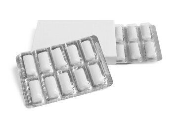 Pack and blisters with tasty chewing gums isolated on white