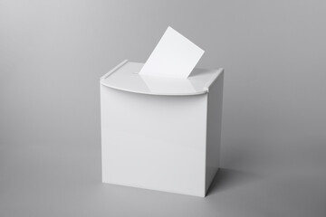 Ballot box with vote on light grey background. Election time