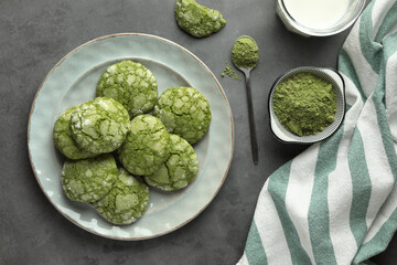 Tasty matcha cookies, powder and milk on grey table, flat lay