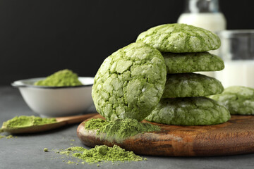 Tasty matcha cookies and powder on grey table, closeup. Space for text