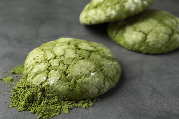 Tasty matcha cookies and powder on grey table, closeup