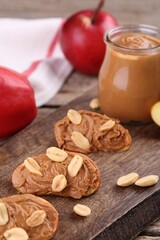 Pieces of fresh apple with peanut butter on table, closeup
