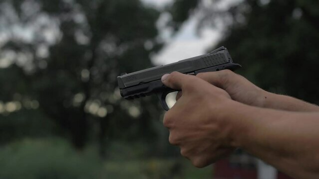 4K 60 Fps Slow Mo Man Fires 44 Mm Hand Gun Shooting Tight Shot Target Bullets Shells Explosions