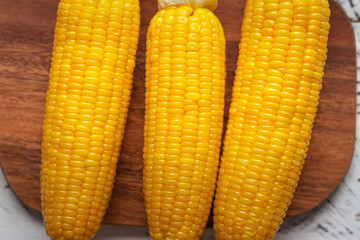 Sweet corn on a wooden cutting board