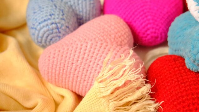 A crochet toy, many knitted colorful hearts.  Amigurumi hobby