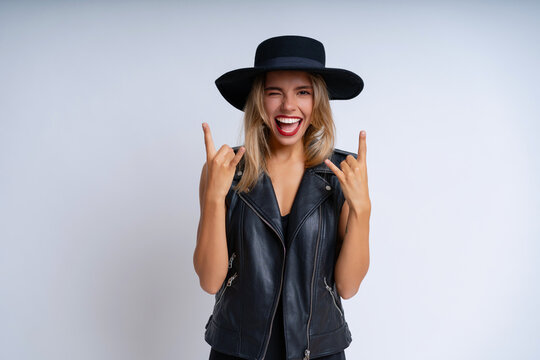 On a white backdrop, a pretty lady sports a black grunge look with lively makeup and a happy demeanor while striking poses. Emotional pretty face
