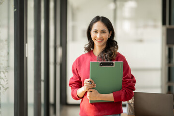 Asian businesswoman working on documents at office