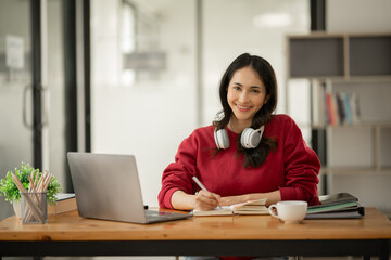 Asian businesswoman working on documents at office