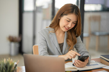 Asian businesswoman working on documents at office