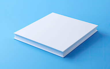 Fototapeta premium A white book on a blue surface