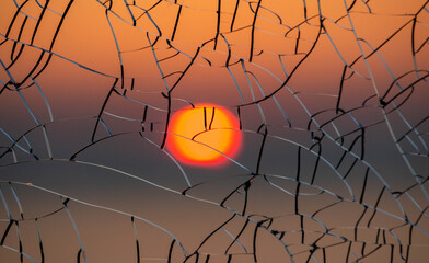 Sun through cracked glass at sunset