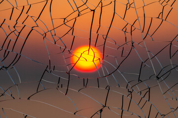 Sun through cracked glass at sunset