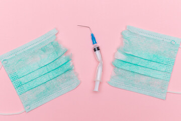 Anti Vaccine Movement and Anti Mask Concept - Broken Medical Syringe and Green Torn Medical Face...