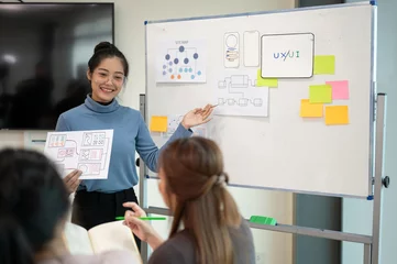 Tuinposter Young smart UX UI designer presenting her idea to the team, presentation during the team meeting. © bongkarn