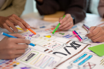 Close up view of young professional UX UI designer discussion on their project in the meeting room.