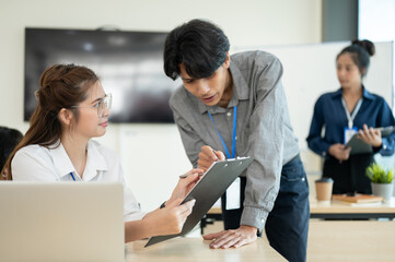 Professional office worker discussing and analyzing the project together in the office room.