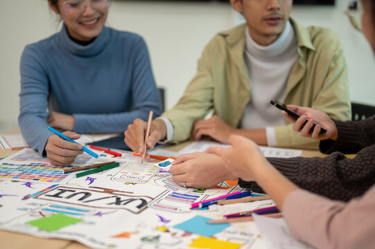 Team of young professional UX/UI designer working together in the meeting room. - Powered by Adobe
