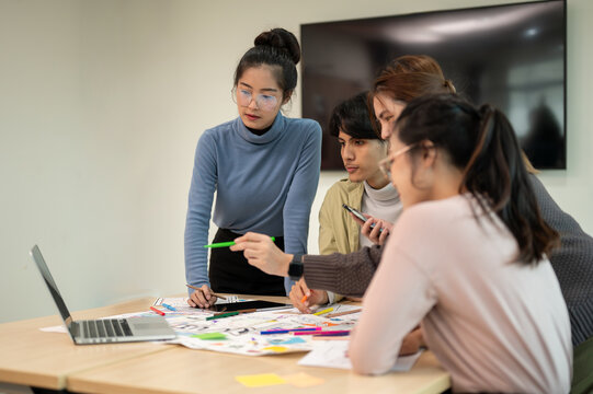 Team of young professional UX/UI designer working together in the meeting room.