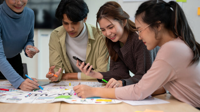 Team of young professional UX/UI designer working together in the meeting room. - Powered by Adobe