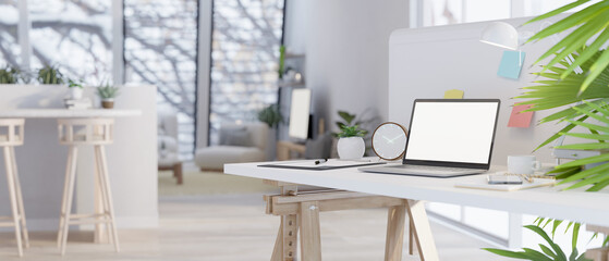 Close-up image of mock up laptop on a table in a modern minimal living room.