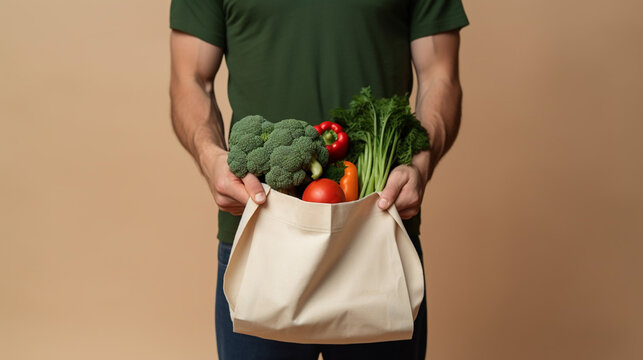 Man Hand Holding Cotton Grocery Bag with Vegetables