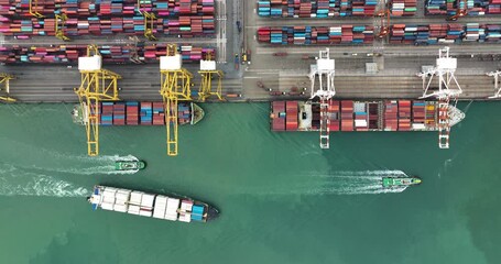logistic container ship and commercial port loading and unloading cargo from container ship import and export by crane for distributing goods by trailers transported, 4k video drone point of view, - Powered by Adobe