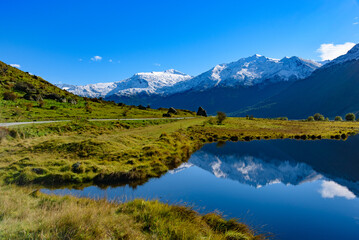 Snow mountains and reflection on lake in South Island, New Zealand