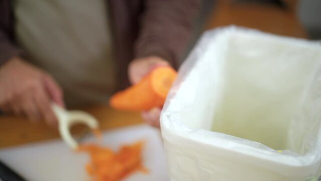 Ecology compost supply Kitchen waste sorting waste vegetable peels to recycle composter environmentally friendly. Man throws leftover fruit peel and vegetables reduce zero waste.