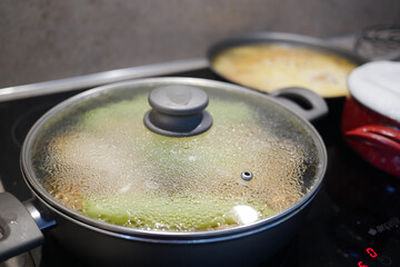 cooking pan on electric stove, electric stove is heated to red. 