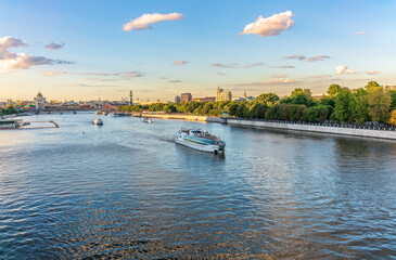 Cruise ship sails on the Moscow river in Moscow city center, popular place for walking.