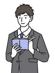 メモを取るスーツを着た男性