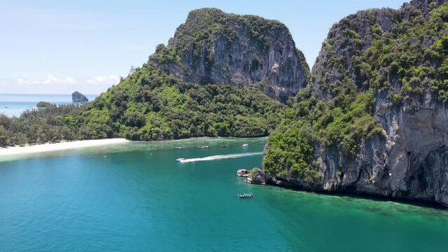 Aerial of speedboat passing between tropical islands, Koh Poda, Krabi