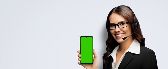 Customer support phone operator in glasses, headset hold show smartphone cell phone mobile green...