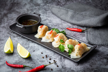 steamed dumplings with herbs, chili and soy sauce