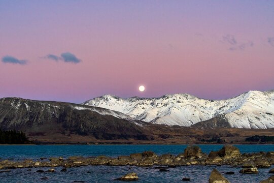 a super moon rises over Mount Dobson on the shores of Lake Tekapo on June 14th 2022 -  Lake Tekapo, Mackenzie Basin, New Zealand