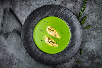 creamy broccoli soup with meat and dill in a black plate