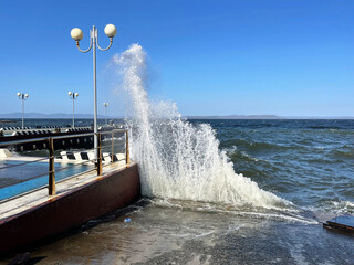 Big waves on the Sports embankment in Vladivostok in windy weather