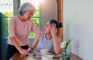 Psychologist session. A middle aged woman in therapy with a senior woman psychologist. Psychiatrist studies and examines patient with drawings and gestures. Psychotherapy concept. 