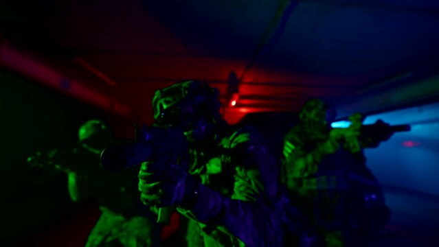 A group of special forces soldiers is preparing for a military operation. An equipped military man holding a machine gun in his hands.