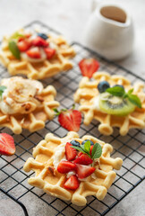 Freshly baked waffles with strawberries and blueberries