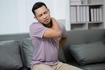 Back pain, kidney inflammation, man suffering from backache at home, health problems concept