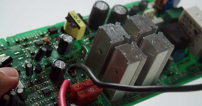 Close-up of a circuit board components under a thorough inspection of an expert technician