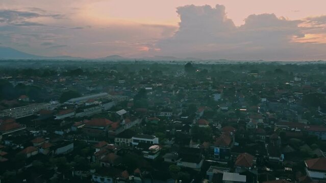 Panoramic panning aerial view of misty morning in Ubud center - Bali at sunrise with mount agung Volcano in Background
