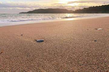 Calm empty sea coast with tranquil water and sunset over mountains. Beautiful European landscapes and nature