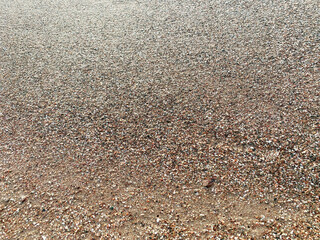 Abstract texture of yellow wet sand on the beach. Nature backgrounds and patterns