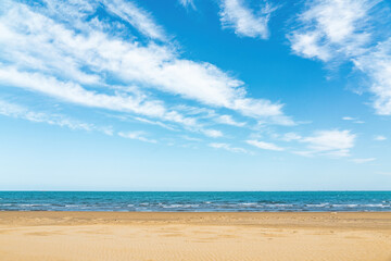 Empty sandy beach and blue sea