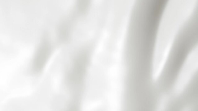 Vertical white liquid cream ripples, close-up fresh milk drink splash texture