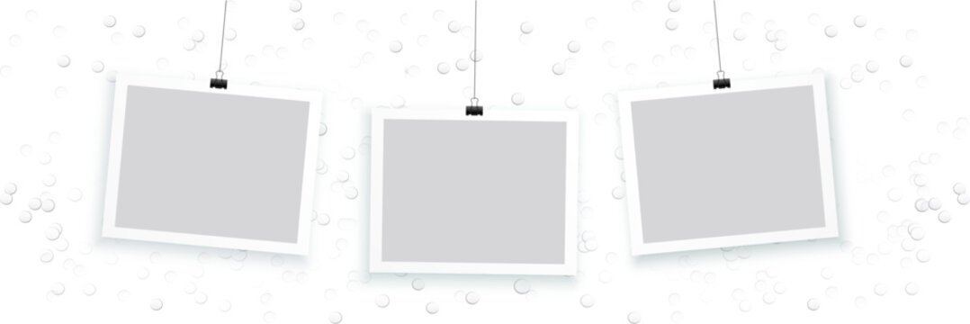 blank photo frames hanging on white background