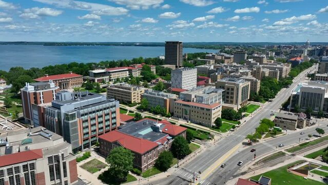 University of Wisconsin main campus in Madison, WI. Aerial shot of academic buildings and dorms on beautiful summer day with Lake Mendota in background.